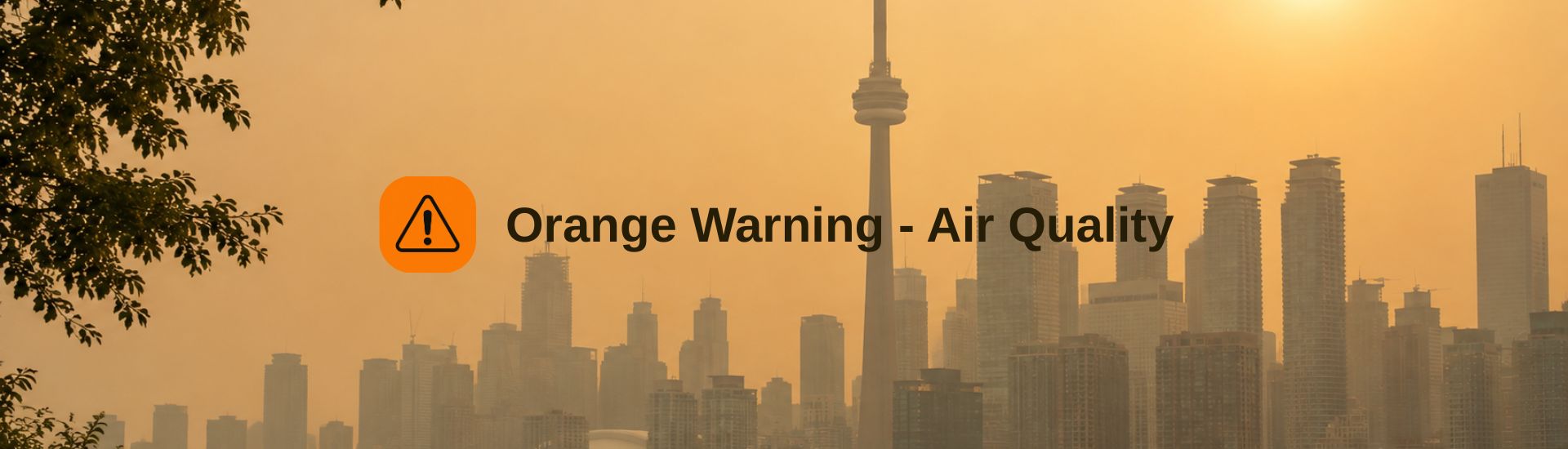 Smog-covered city skyline during an orange air quality warning, with dense haze reducing visibility and indicating unhealthy air quality.
