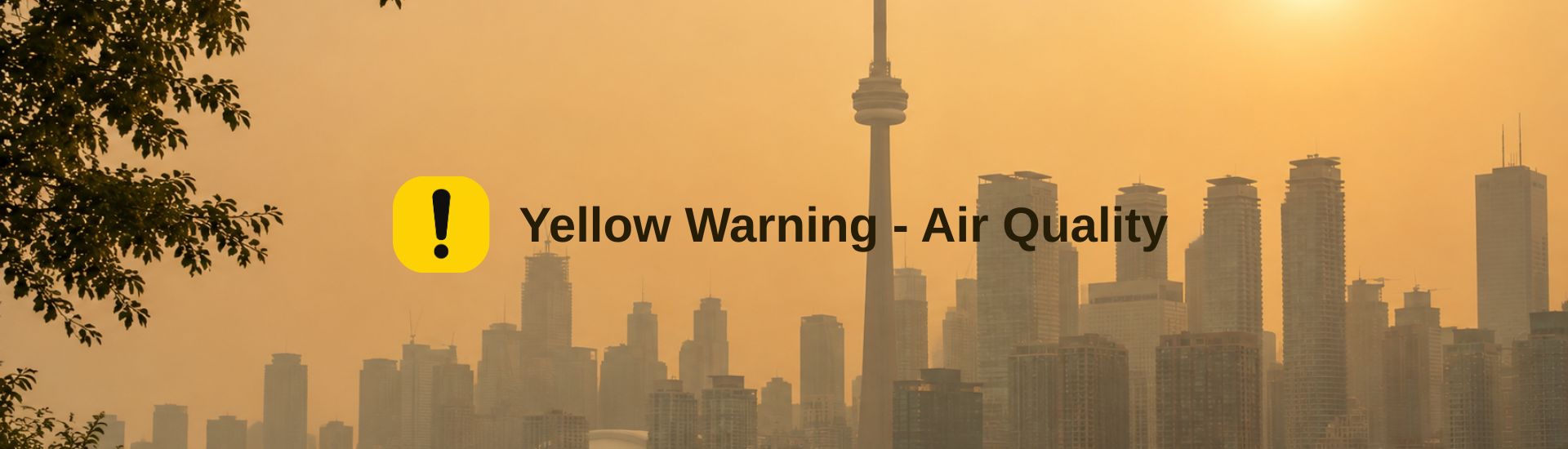 Hazy city skyline during a yellow air quality warning, with smog reducing visibility and indicating moderate air pollution.
